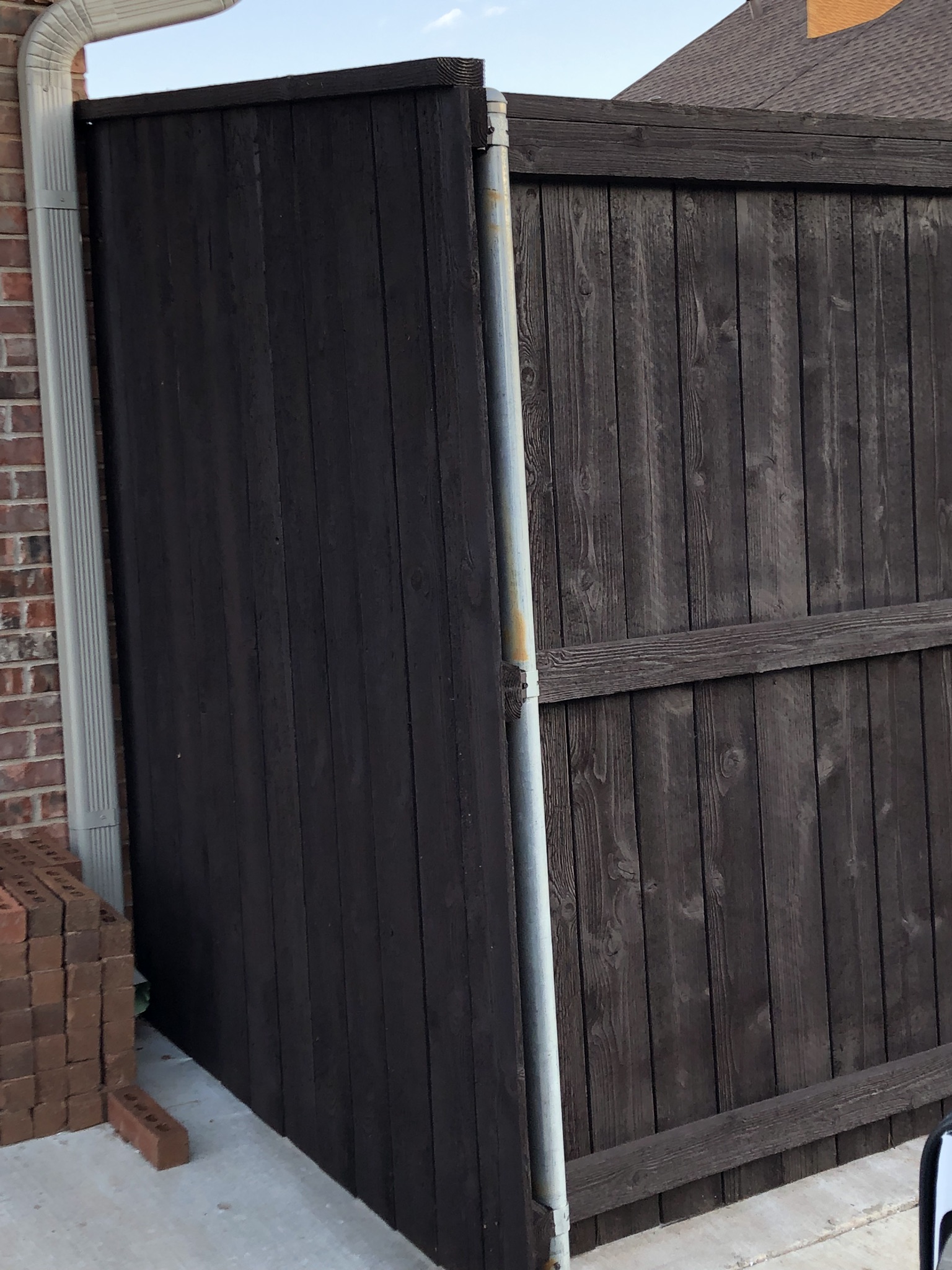 New cedar privacy fence build on green grass lot