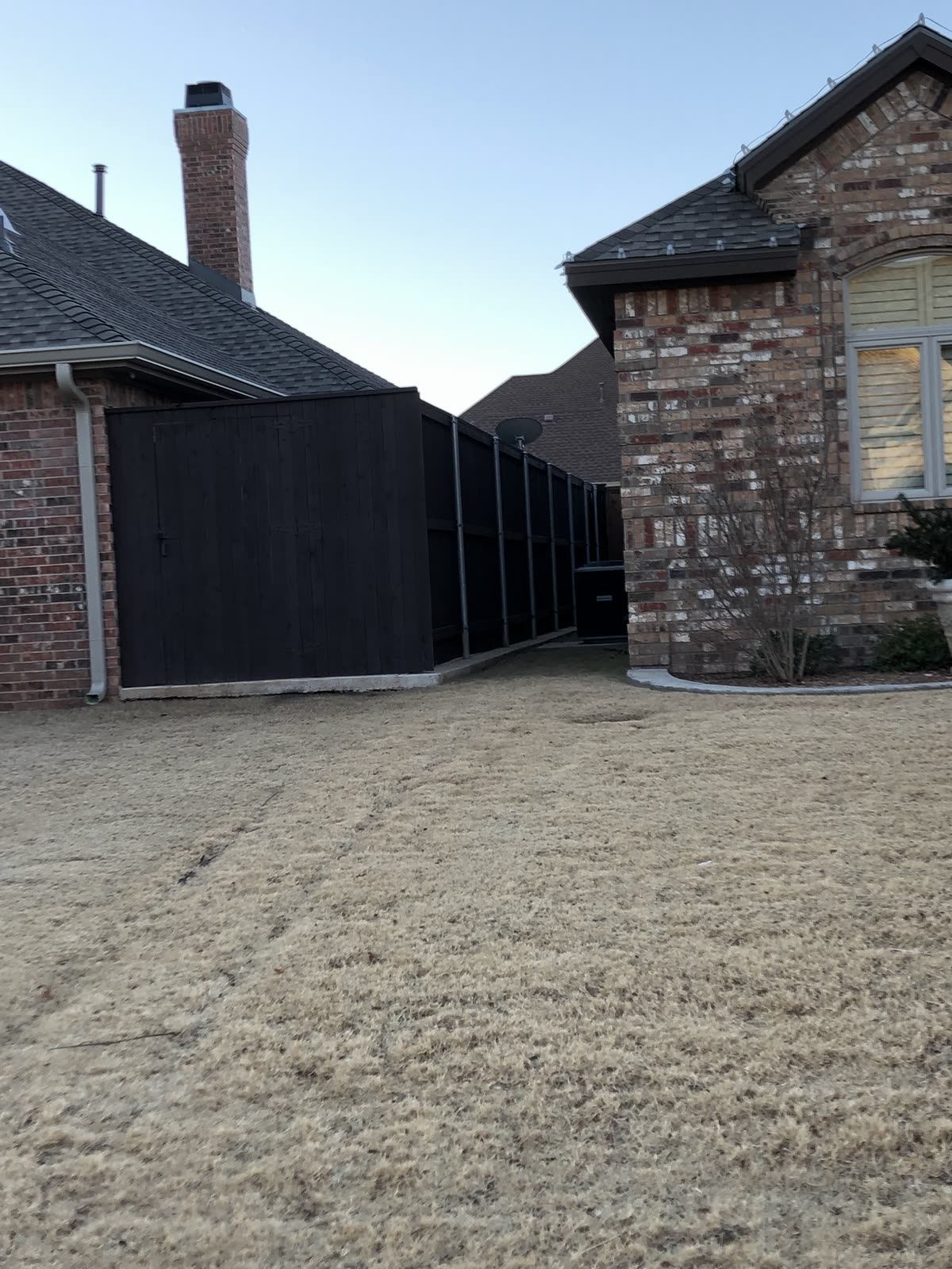 Dark stained wood fence with a rich finished color